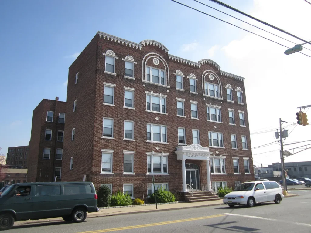 A brick apartment building on a street in Hackensack, New Jersey