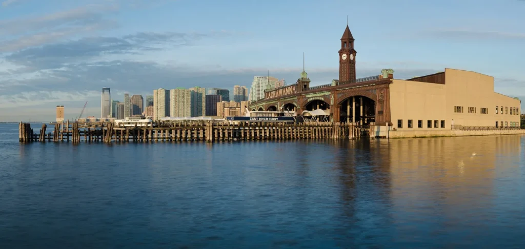 Hoboken Terminal on the Hudson River, with the Jersey City skyline behind it